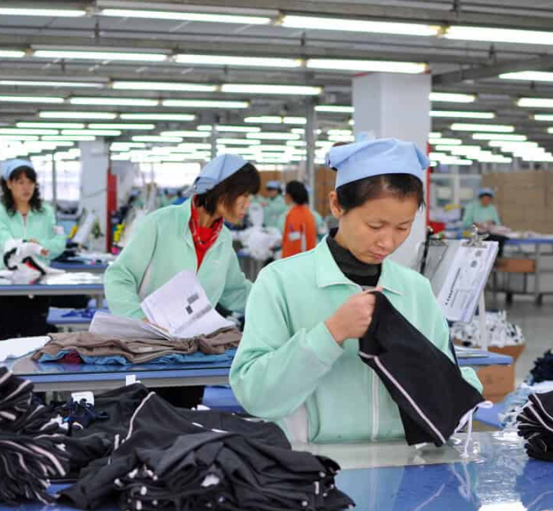 Well Fit quality assurance team inspecting finished garments